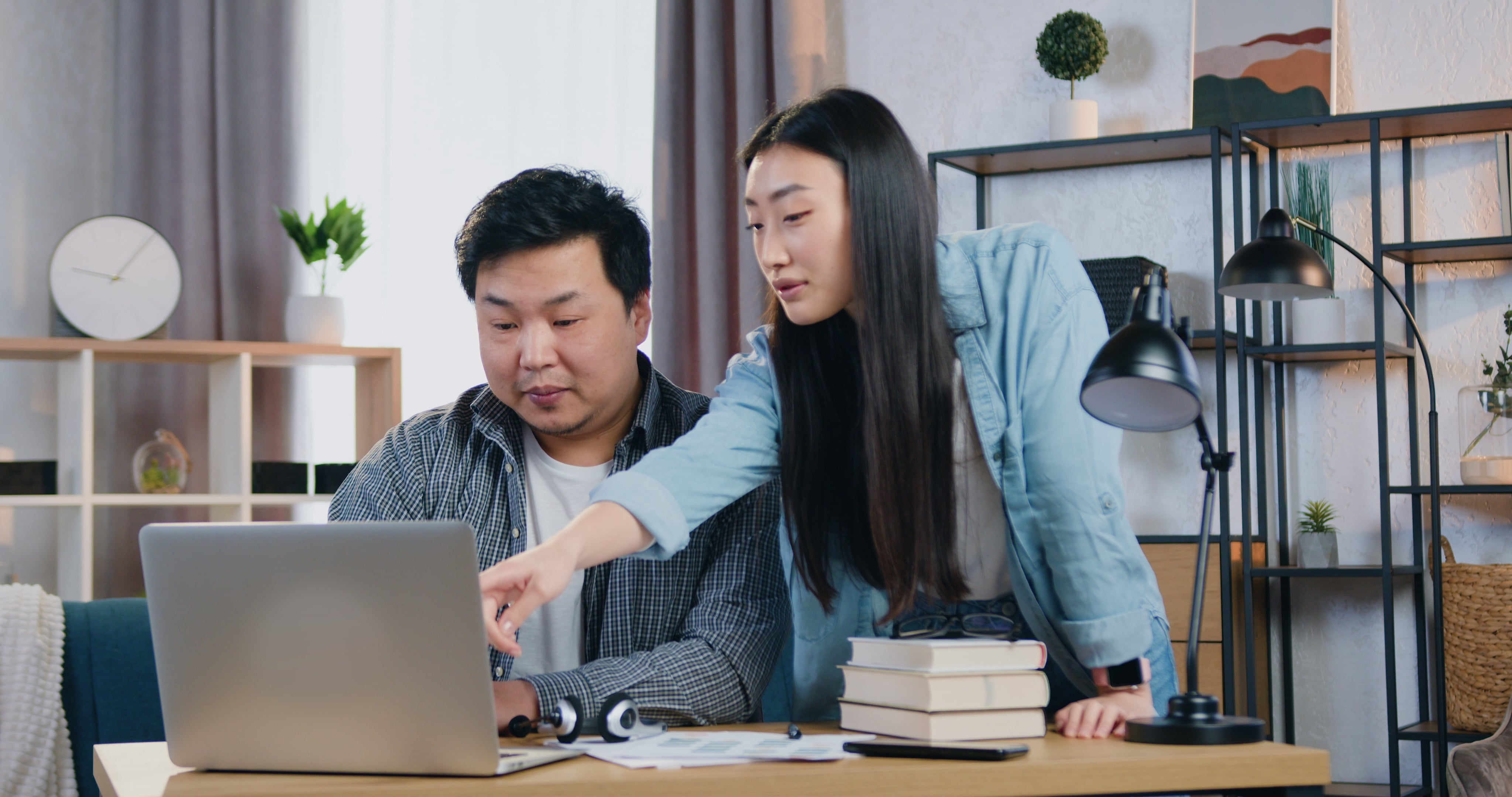 Two creative collaborating in their office, figuring out their staffing needs and work schedule