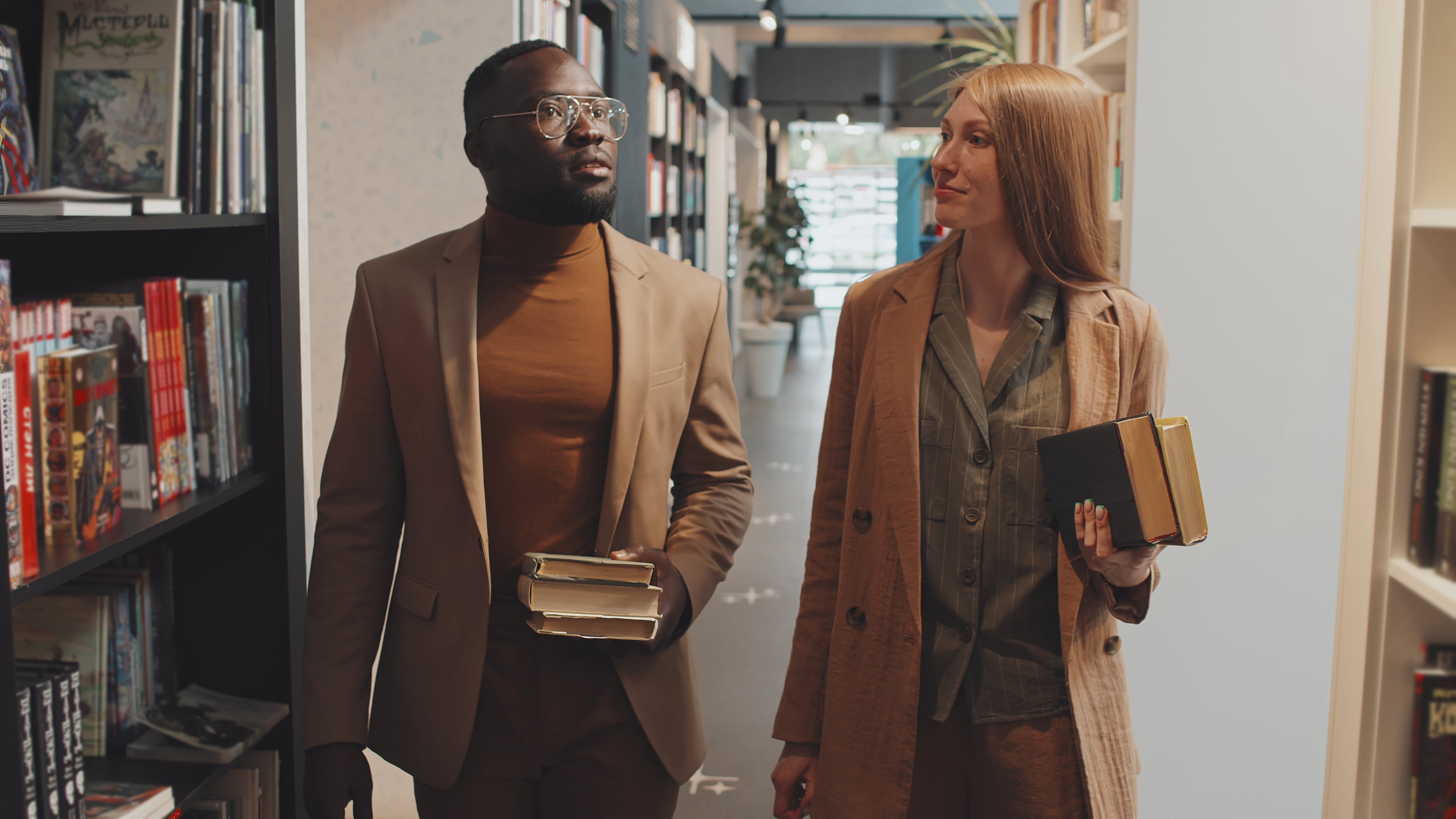 Two TAs walking through university library